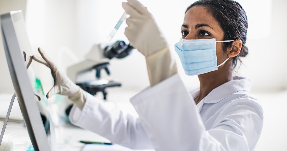 Technician analyzing the content of a test tube