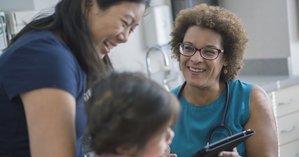 A woman and child talking to a healthcare professional