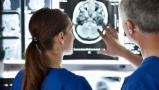 Two healthcare professionals looking at diagnostic images
