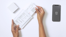 User opening up the Cue Health Monitoring System