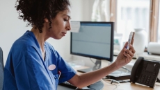 A doctor talking with a patient on a video call on her smartphone.