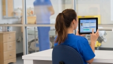 Healthcare provider in the hospital setting looking at a tablet