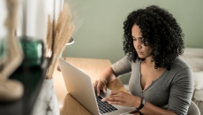 Person sitting down and looking at a computer