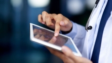 A close-up of a doctor using a tablet.