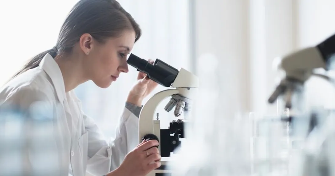 Clinician looking through a microscope