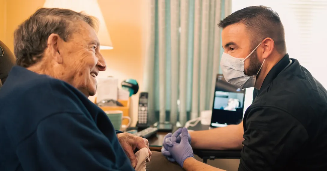 
  An Atrium Health community paramedic consults with patient in his home.
