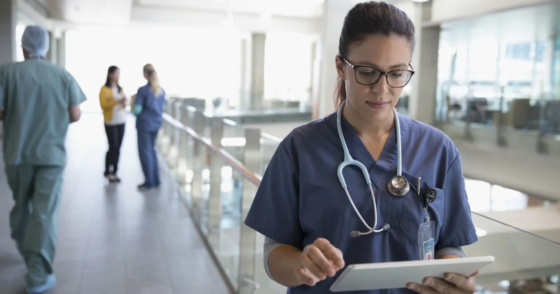 
  Healthcare professional looking at a tablet
