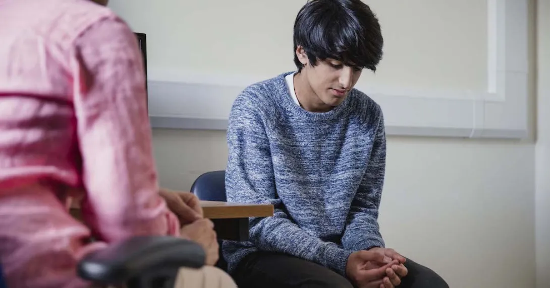
  Two people sitting in a room 
