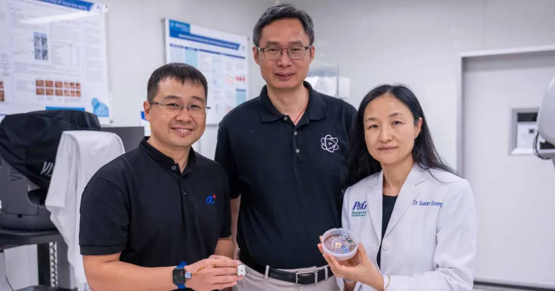 Representatives from NTU Singapore, Procter & Gamble, and Agency for Science, Technology and Research pose side-by-side while showing the HapSense ring-type device for skincare cosmetic product analysis.
