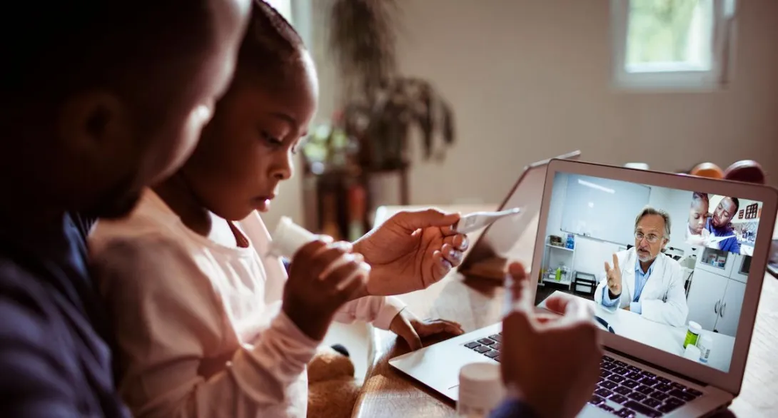 
  Adult and child talking to a provider through a video chat
