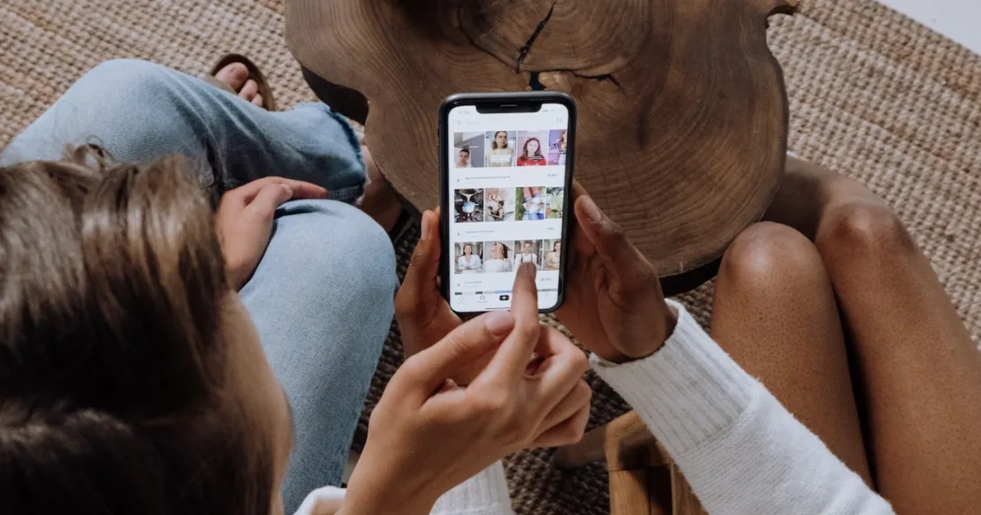 
  Two persons using the Tiktok app on a mobile phone
