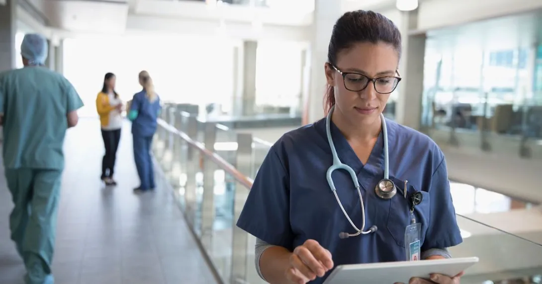 
  Healthcare provider looking at a tablet
