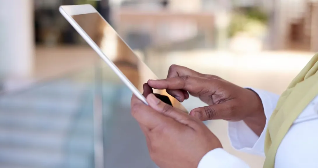 
  Person on a tablet wearing a yellow scarf and white shirt
