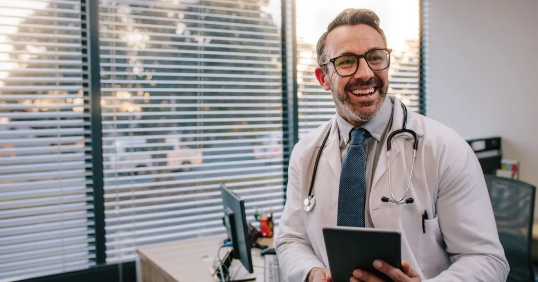 Doctor standing in a room and smiling
