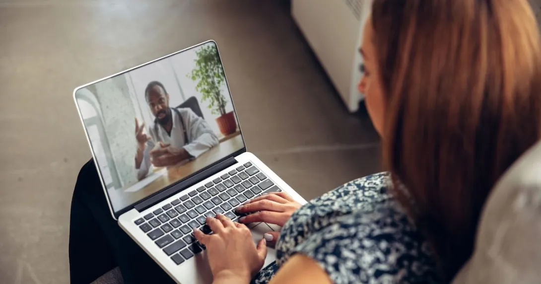 
  Person on a computer speaking with a healthcare provider
