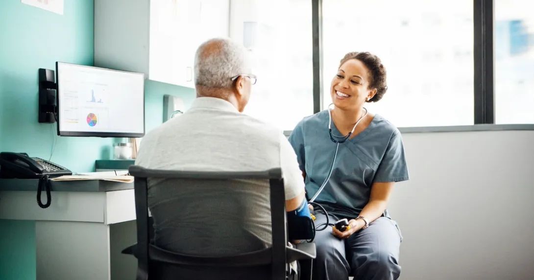 Healthcare provider talking in a patient in a clinical setting Healthcare provider talking in a patient in a clinical setting