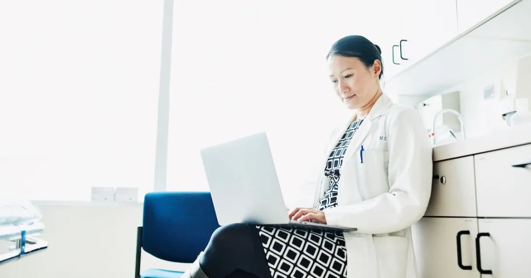 A doctor answering online inquiries on a laptop
A doctor answering online inquiries on a laptop