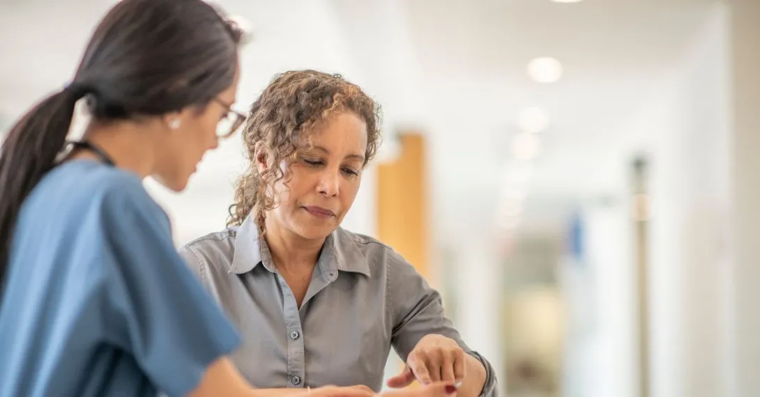 
  A person talking to her doctor.
