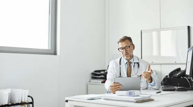 Doctor looking at tablet