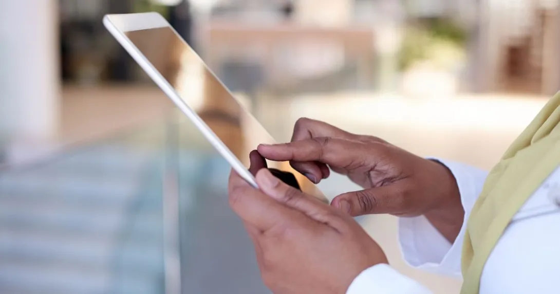 A close-up of a person holding a tablet