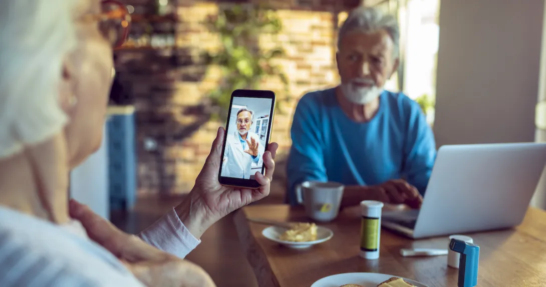 An older couple talking to a provider via telehealth