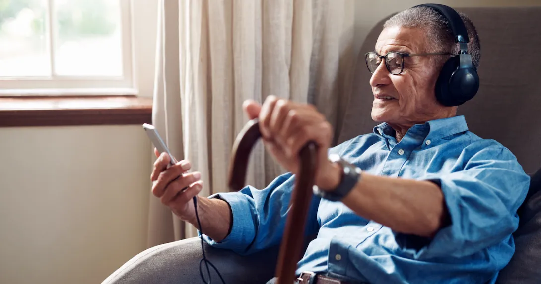 An older man looking at a smartphone