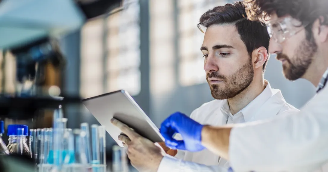 Researchers in a lab using an iPad.