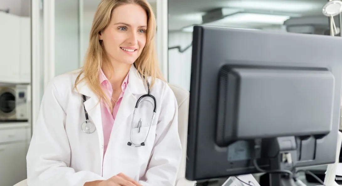 Healthcare provider looking at a computer Healthcare provider looking at a computer