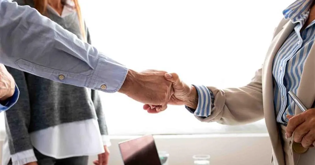Man and woman shaking hands in the office Man and woman shaking hands in the office